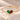 Demi Heart Bracelet in gold with May emerald and January garnet pear-cut stones forming a heart
