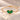 Demi Heart Bracelet in gold with two May emerald pear-cut stones forming a heart