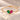 Demi Heart Bracelet in gold with May emerald and July ruby pear-cut stones forming a heart