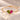 Demi Heart Bracelet in gold with August peridot and July ruby pear-cut stones forming a heart