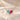 Demi Heart Necklace in gold with March aquamarine and July ruby pear-cut stones forming a heart