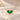 Demi Heart Necklace in gold with two May emerald pear-cut stones forming a heart