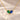 Demi Heart Necklace in gold with May emerald and September sapphire pear-cut stones forming a heart