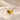 Demi Heart Necklace in gold with August peridot and November topaz pear-cut stones forming a heart