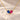 Demi Heart Necklace in gold with September sapphire and July ruby pear-cut stones forming a heart