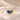 Demi Heart Necklace in gold with September sapphire and August peridot pear-cut stones forming a heart